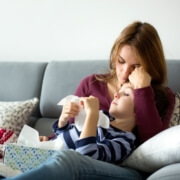 mother with sick child on sofa shutterstock 12_5_2017