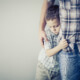 sad boy clutching father